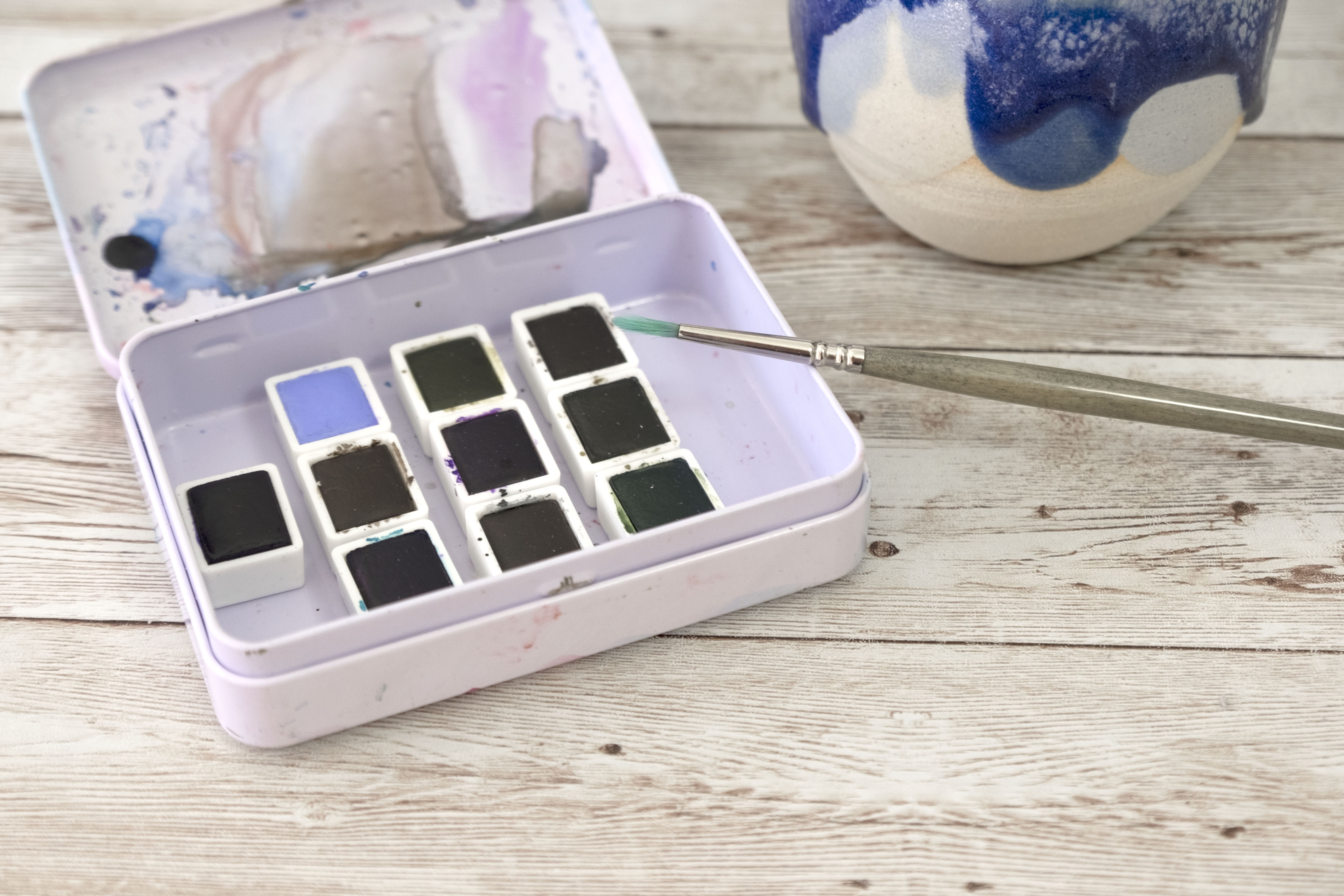 Store pan watercolors in a metal box and secure them with magnetic strips.